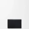 Anagram business cardholder in pebble grained calfskin Black/Gold