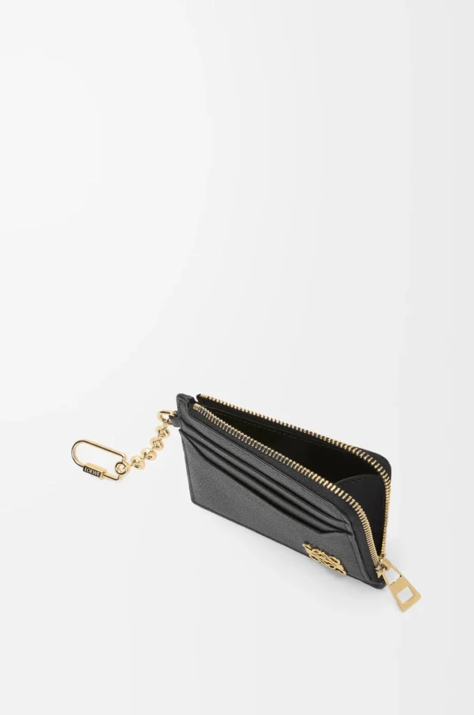 Anagram square coin cardholder in pebble grained calfskin Black/Gold Anagram square coin cardholder in pebble grained calfskin Black/Gold