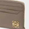 Anagram square coin cardholder in pebble grained calfskin Taupe Anagram square coin cardholder in pebble grained calfskin Taupe