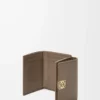 Anagram trifold wallet in pebble grained calfskin Taupe Anagram trifold wallet in pebble grained calfskin Taupe