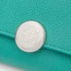 Pebble small vertical wallet in pebble grained calfskin Aquamarine