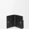 Puzzle slim compact wallet in supple grained calfskin Black