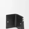 Puzzle slim compact wallet in supple grained calfskin Black