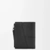 Puzzle slim compact wallet in supple grained calfskin Black